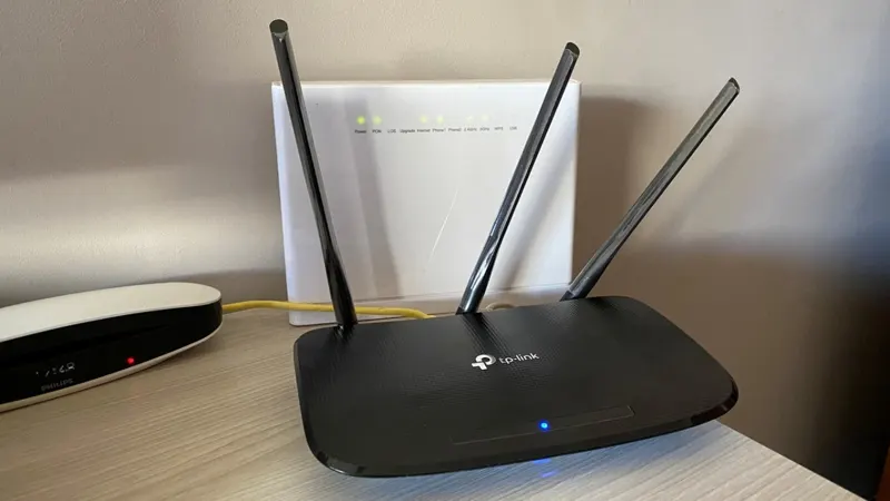 A home Wi-Fi router with three antennas on a desk